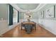 Charming dining room showcasing an elegant light fixture, modern decor, and plenty of natural light at 121 Hardy Oaks Way, Holly Springs, NC 27540