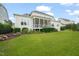 Exterior view showcasing the home's well-maintained lawn, screened porch and manicured landscaping at 121 Hardy Oaks Way, Holly Springs, NC 27540