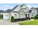 Attractive home with a spacious driveway and well-maintained landscaping with a partial garage view at 121 Hardy Oaks Way, Holly Springs, NC 27540