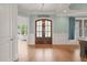Foyer showcasing a decorative ceiling, beautiful wood flooring, and glass-paneled front doors at 121 Hardy Oaks Way, Holly Springs, NC 27540