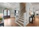 Grand foyer with coffered ceilings, hardwood floors, staircase, and elegant chandelier at 121 Hardy Oaks Way, Holly Springs, NC 27540