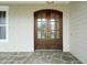 Elegant wood front door with glass panes, complemented by stone pathway at 121 Hardy Oaks Way, Holly Springs, NC 27540
