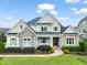 Beautiful home showcasing stone accents, manicured landscaping, and a welcoming front entrance at 121 Hardy Oaks Way, Holly Springs, NC 27540
