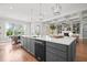 Open concept kitchen with a large island, stainless steel dishwasher, and view of the dining and living areas at 121 Hardy Oaks Way, Holly Springs, NC 27540