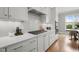 Modern kitchen with white cabinets, subway tile backsplash, stainless steel appliances, and a gas cooktop at 121 Hardy Oaks Way, Holly Springs, NC 27540
