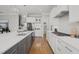 Bright and modern kitchen featuring a large island, white cabinets, and stainless steel appliances at 121 Hardy Oaks Way, Holly Springs, NC 27540