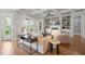 Bright living room featuring built-in bookshelves, a fireplace, and large windows at 121 Hardy Oaks Way, Holly Springs, NC 27540