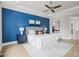 Comfortable main bedroom has hardwood floors, tray ceiling, and designer color scheme at 121 Hardy Oaks Way, Holly Springs, NC 27540