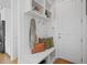 Mudroom with a bench, coat hooks, storage shelves, and access to the garage and kitchen at 121 Hardy Oaks Way, Holly Springs, NC 27540