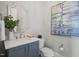 Cozy powder room featuring a decorative mirror, elegant vanity, and charming decor at 121 Hardy Oaks Way, Holly Springs, NC 27540