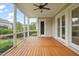 Covered porch with ceiling fan, wood flooring and backyard views is perfect for relaxing and entertaining at 121 Hardy Oaks Way, Holly Springs, NC 27540