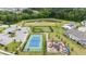 Aerial view of community amenities: tennis court, playground, sport field, and a pond at 1428 Wrenn Rd, Durham, NC 27703