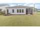 Spacious backyard featuring a well-maintained lawn and a screened porch at 1428 Wrenn Rd, Durham, NC 27703
