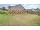 View of the home's backyard, featuring a sloped garden and a wooden fence at 1428 Wrenn Rd, Durham, NC 27703