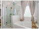 Elegant bathroom with a soaking tub, walk-in shower, and modern fixtures at 1428 Wrenn Rd, Durham, NC 27703