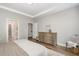 Spacious bedroom featuring tray ceilings, hardwood floors, and neutral decor at 1428 Wrenn Rd, Durham, NC 27703