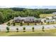 Community clubhouse with beautiful landscaping and trees lining the front of the property at 1428 Wrenn Rd, Durham, NC 27703