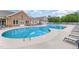 Large community pool surrounded by lounge chairs, perfect for relaxing and enjoying the outdoors at 1428 Wrenn Rd, Durham, NC 27703