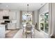 Charming dining area with large windows, and stylish lighting fixture at 1428 Wrenn Rd, Durham, NC 27703