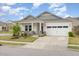 Beautiful single-Gathering home with a two-car garage, charming porch, and well-maintained front yard at 1428 Wrenn Rd, Durham, NC 27703