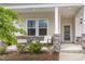 Inviting front porch with rocking chairs and stone accents create a welcoming entrance at 1428 Wrenn Rd, Durham, NC 27703