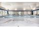 Beautiful indoor pool area with ample seating and natural light, perfect for year-round enjoyment and relaxation at 1428 Wrenn Rd, Durham, NC 27703