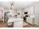 Well-lit modern kitchen featuring white cabinetry, stainless steel appliances, and a spacious island at 1428 Wrenn Rd, Durham, NC 27703