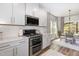 Modern kitchen featuring white cabinets, stainless steel appliances, and granite countertops at 1428 Wrenn Rd, Durham, NC 27703