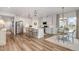 Open-concept kitchen with island seating, stainless steel appliances, and adjacent dining area at 1428 Wrenn Rd, Durham, NC 27703