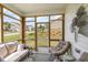Inviting screened porch with comfortable seating and a view of the yard at 1428 Wrenn Rd, Durham, NC 27703