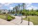 Community tennis court with picnic table, grill, landscaping, and adjacent home for recreational opportunities at 1428 Wrenn Rd, Durham, NC 27703