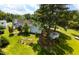 Aerial view showcasing a spacious backyard, lush greenery, and detached garage at 2016 Cypress Ct, Clayton, NC 27520