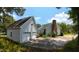 Exterior view of a home featuring a detached garage, chimney, and spacious driveway at 2016 Cypress Ct, Clayton, NC 27520