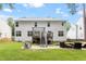 Exterior of home with a fenced backyard, stone patio, metal staircase and an upper deck at 2422 Castleburg Dr, Apex, NC 27523