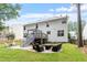 Exterior of home with a fenced backyard, stone patio, metal staircase and an upper deck at 2422 Castleburg Dr, Apex, NC 27523