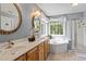 Primary bathroom featuring double vanity, soaking tub, and separate shower at 2422 Castleburg Dr, Apex, NC 27523