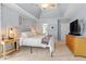 Bright bedroom with tray ceiling, large windows, and neutral decor at 2422 Castleburg Dr, Apex, NC 27523