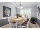 Charming dining room with modern lighting, seating for six, and natural light for a cozy meal at 2422 Castleburg Dr, Apex, NC 27523