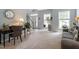 Inviting foyer with natural light, plants, a view of the staircase, and comfortable seating, creating a warm entrance at 2422 Castleburg Dr, Apex, NC 27523