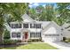 Charming two-story white home with black shutters, a red door and attached two-car garage at 2422 Castleburg Dr, Apex, NC 27523