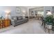 Cozy living room with a grey couch, artwork, and a view into the dining room, creating an inviting atmosphere at 2422 Castleburg Dr, Apex, NC 27523