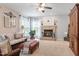 Inviting living room with a brick fireplace, large windows, comfortable seating, and a ceiling fan at 2422 Castleburg Dr, Apex, NC 27523