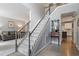 Bright foyer features a staircase with carpeted steps and a view into the living room and kitchen at 2422 Castleburg Dr, Apex, NC 27523