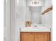 Compact half bathroom with a wooden vanity and a large mirror at 2602 Hitchcock Dr, Durham, NC 27705