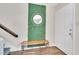 Welcoming foyer with decorative mirror, bench, and light hardwood flooring at 2602 Hitchcock Dr, Durham, NC 27705