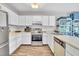 Functional kitchen with bright white cabinets, stainless steel appliances, and tiled backsplash at 2602 Hitchcock Dr, Durham, NC 27705