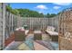 Charming patio with comfortable wicker seating, colorful pillows and a vibrant painted concrete at 2602 Hitchcock Dr, Durham, NC 27705