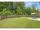 The expansive backyard features a lush lawn, a privacy fence, and a patio set, perfect for outdoor enjoyment at 267 Dando St, Garner, NC 27529