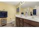 Bathroom featuring double sinks, updated fixtures and vanity with storage at 267 Dando St, Garner, NC 27529