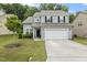 Charming two-story home with a well-manicured lawn and a two-car garage at 267 Dando St, Garner, NC 27529